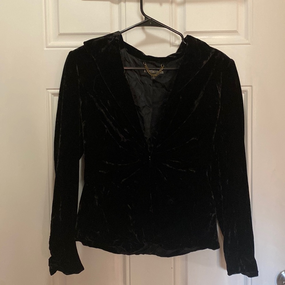 Black velvet jacket with shoulder pads.